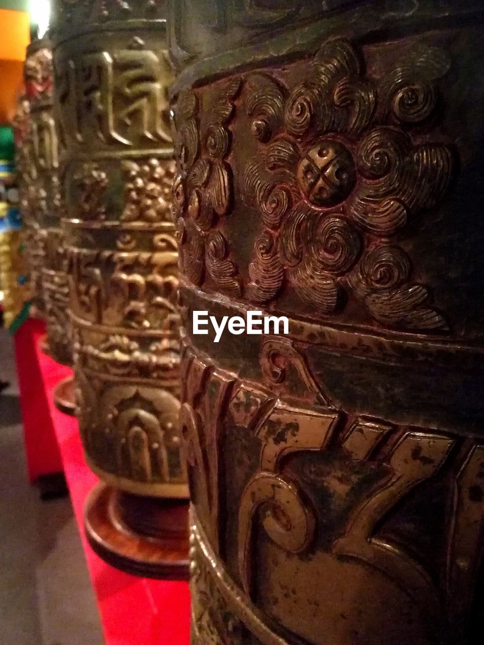 Close-up of prayer wheels in buddhist temple