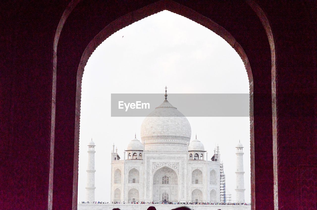 Taj mahal against clear sky seen through arch