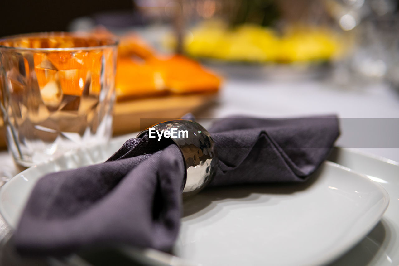 food and drink, meal, tableware, selective focus, table, household equipment, glass, close-up, plate, drinking glass, drink, food, business, indoors, no people, restaurant, refreshment, focus on foreground, crockery