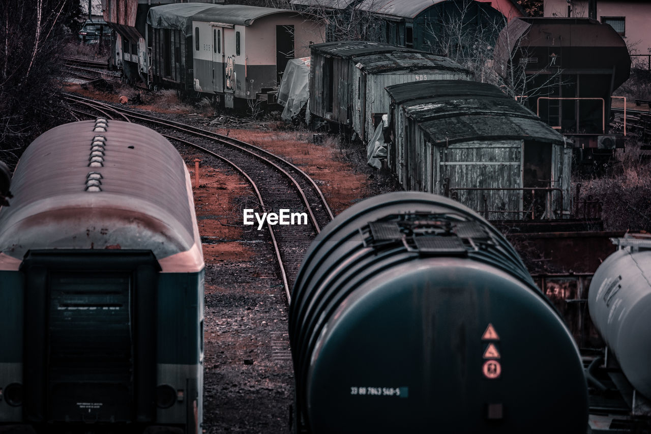 TRAIN ON RAILROAD TRACK IN CITY BUILDINGS