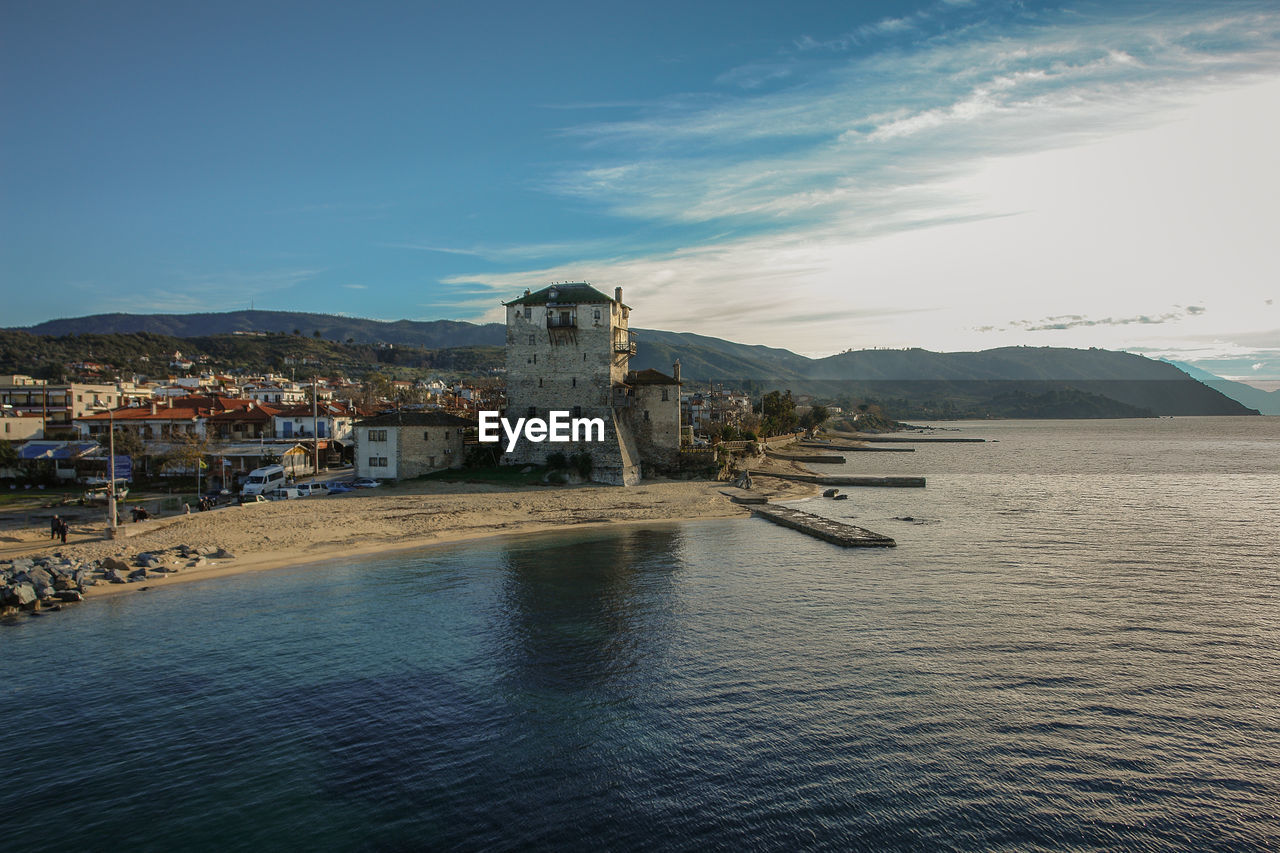 Scenic view of sea and buildings against sky