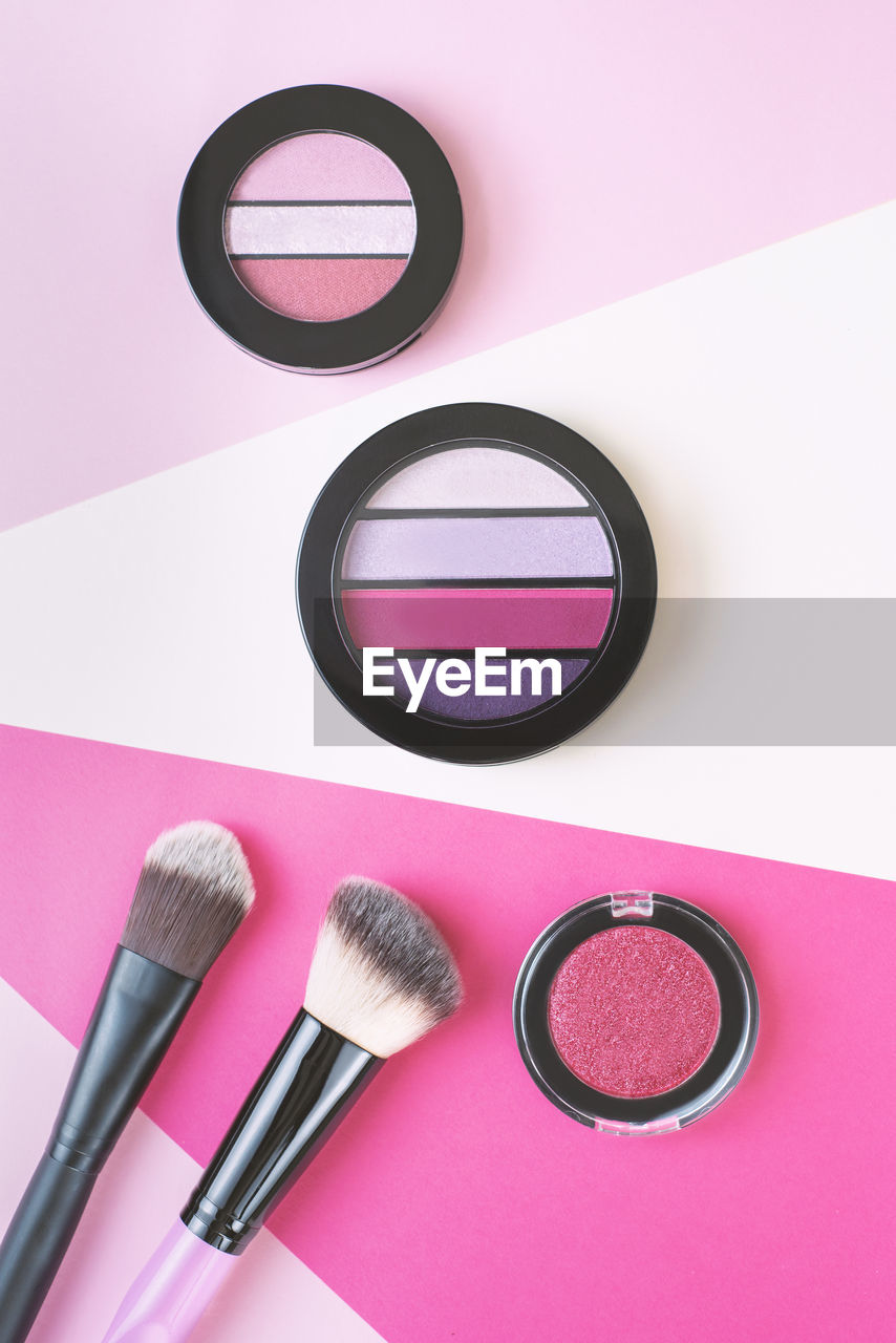 Directly above shot of blusher and brushes on table