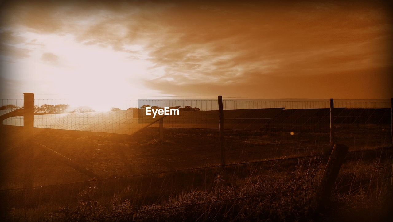 Scenic view of field against sky during sunset