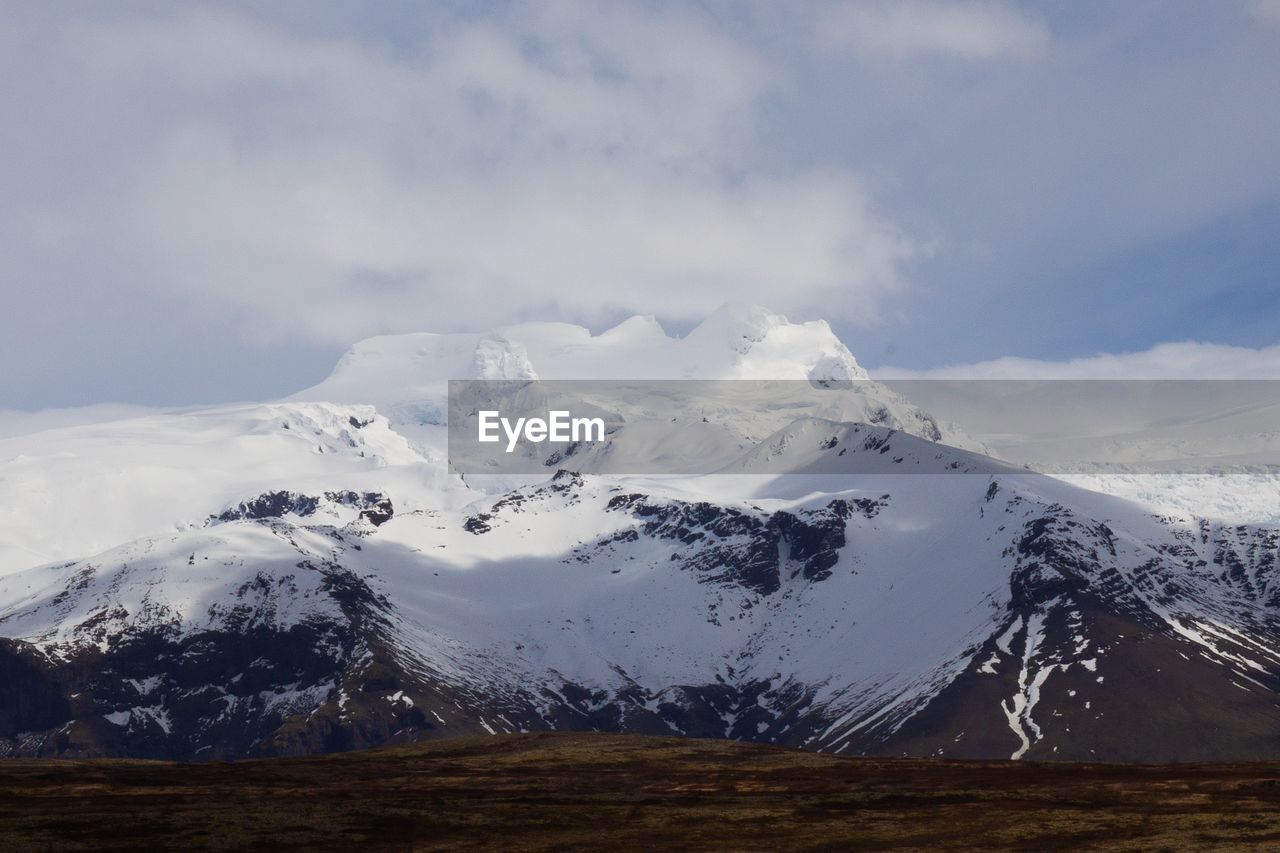 Scenic view of snowcapped mountains against sky