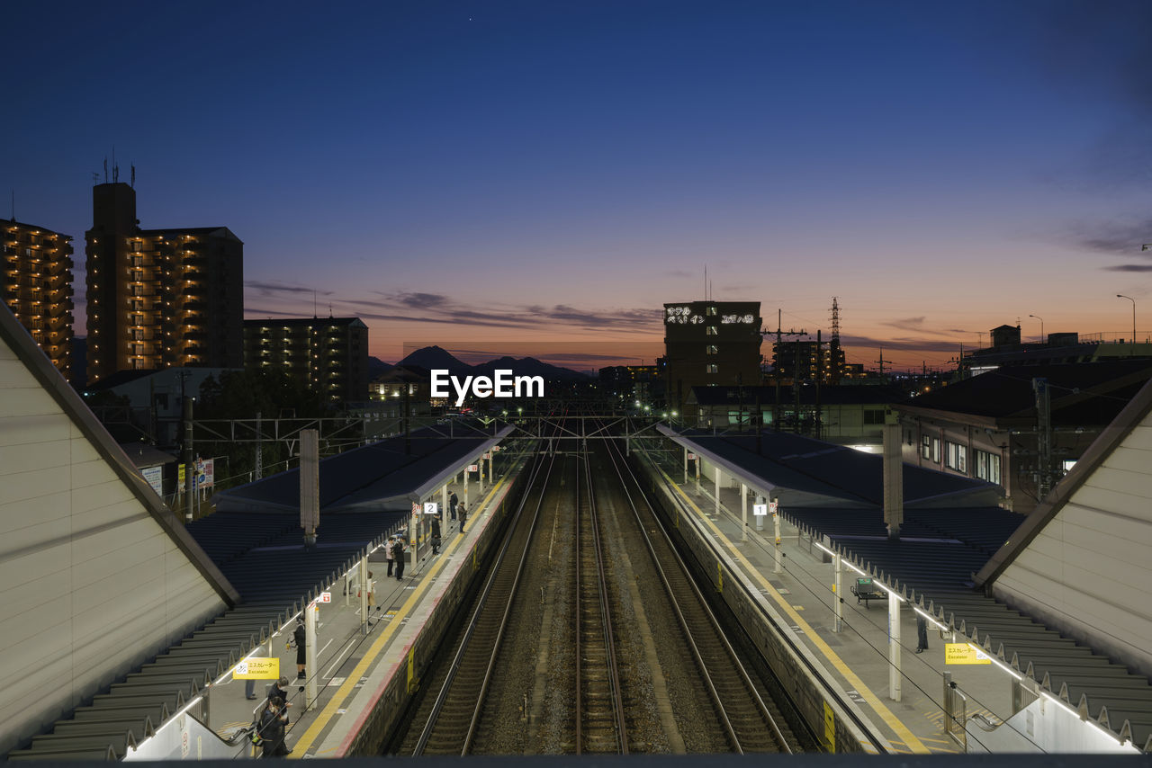 HIGH ANGLE VIEW OF RAILROAD STATION AGAINST SKY