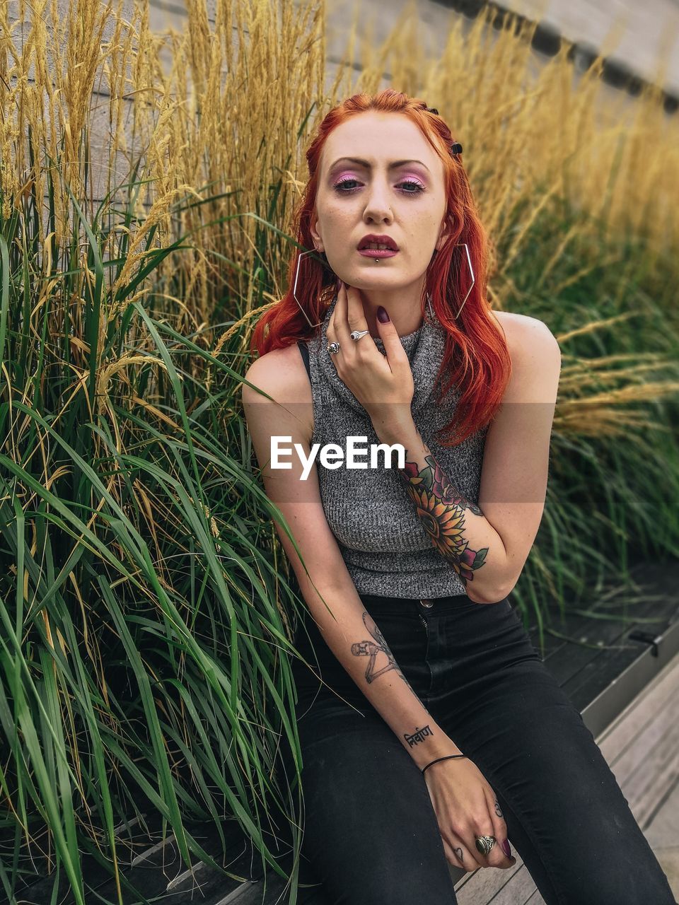 PORTRAIT OF BEAUTIFUL YOUNG WOMAN WITH PLANTS