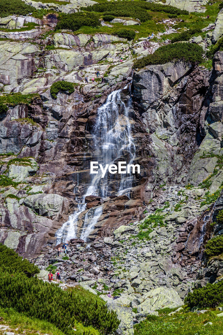 SCENIC VIEW OF WATERFALL ON ROCK