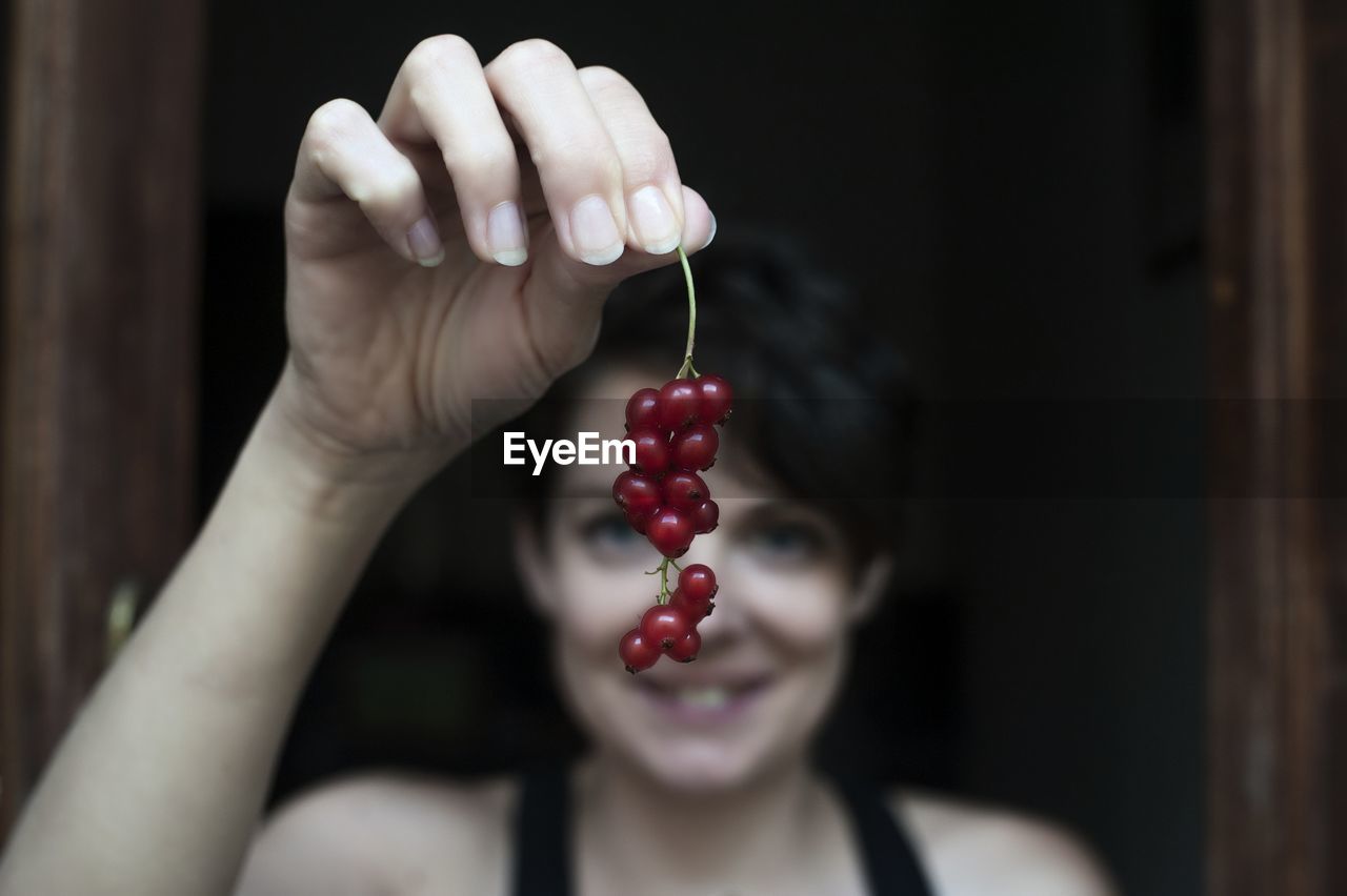 Close-up of woman holding currant