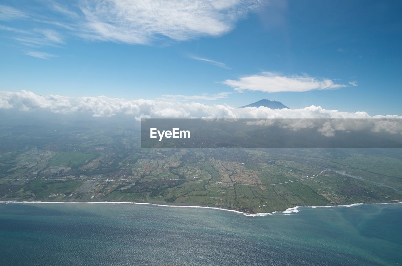 Aerial view of sea and mountains against sky