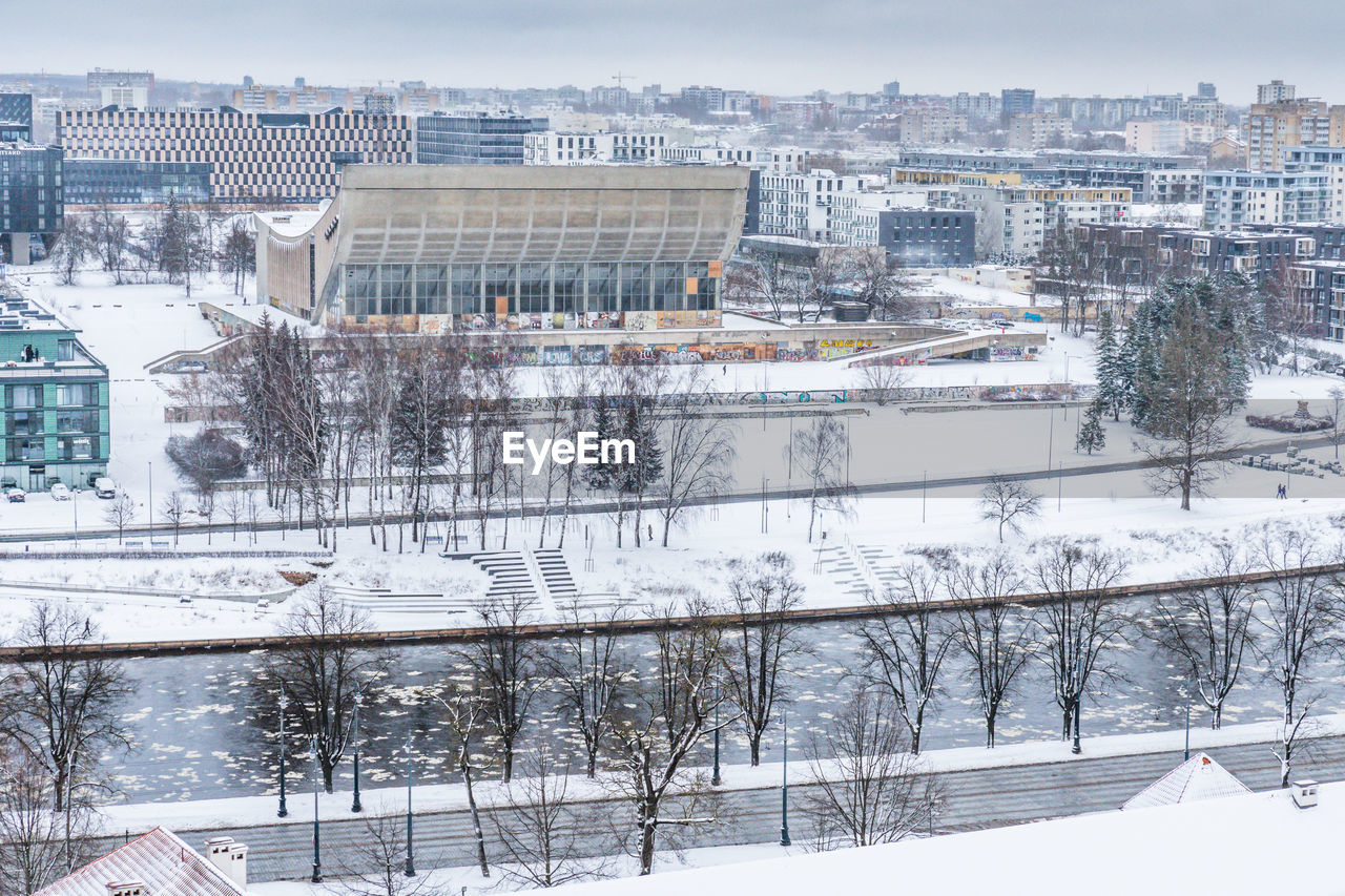 High angle view of cityscape with a river and an abandoned building on a overcast winter day