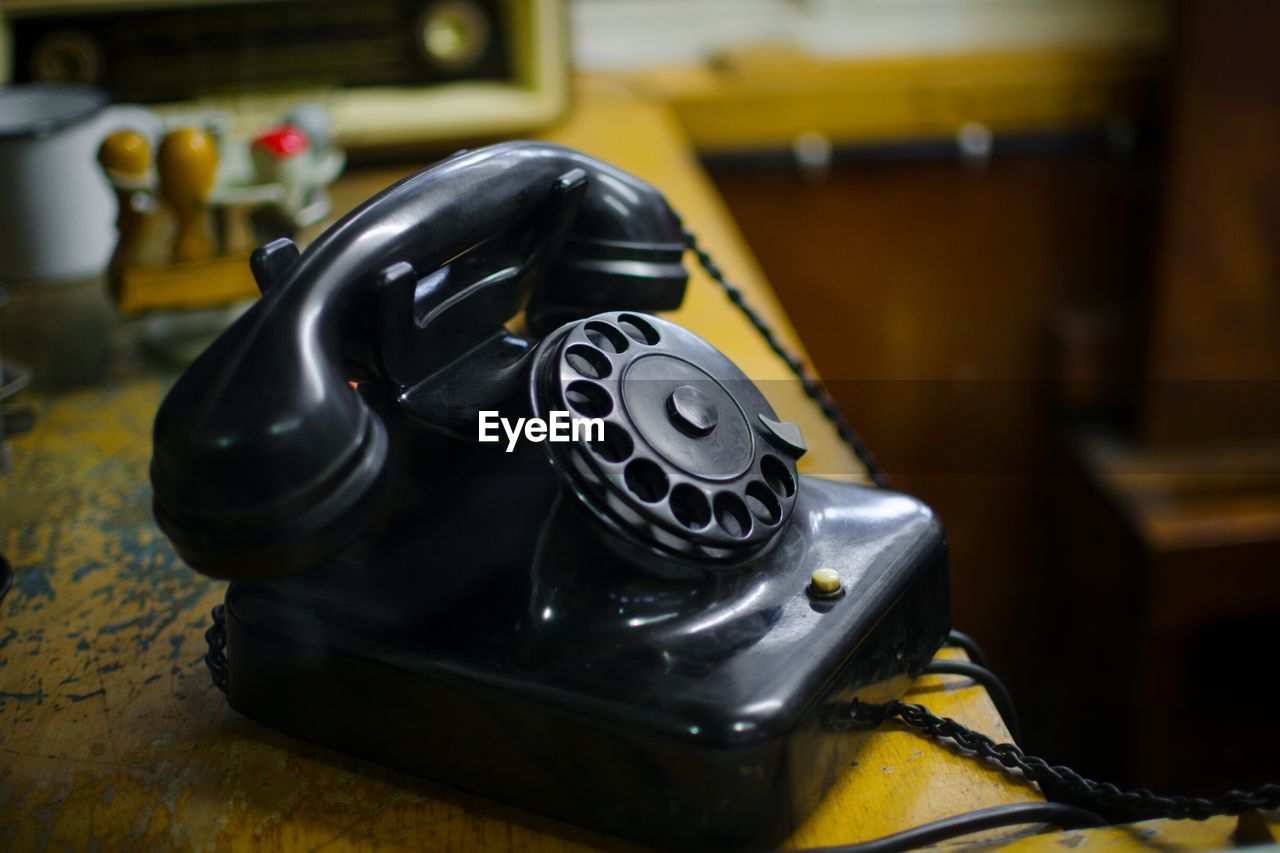 Close-up of vintage black telephone on table