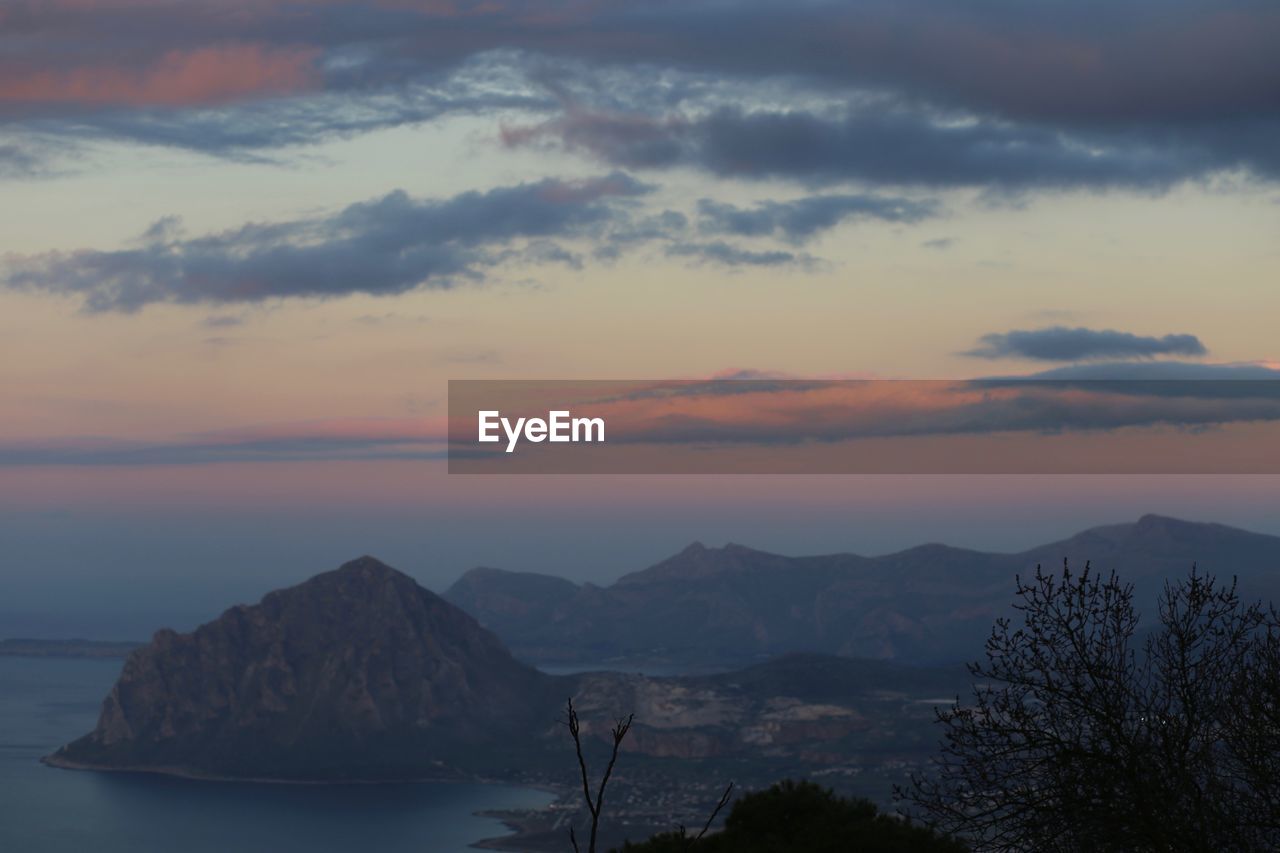 Scenic view of mountains against sky at sunset