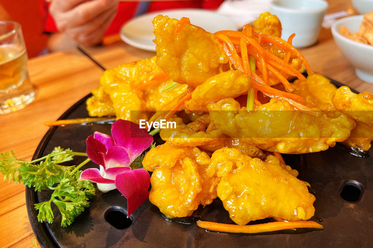 food and drink, food, freshness, dish, meal, healthy eating, table, plate, hand, fast food, indoors, cuisine, wellbeing, vegetable, asian food, produce, close-up, restaurant, business, bowl, flower, fruit, serving size, one person, snack