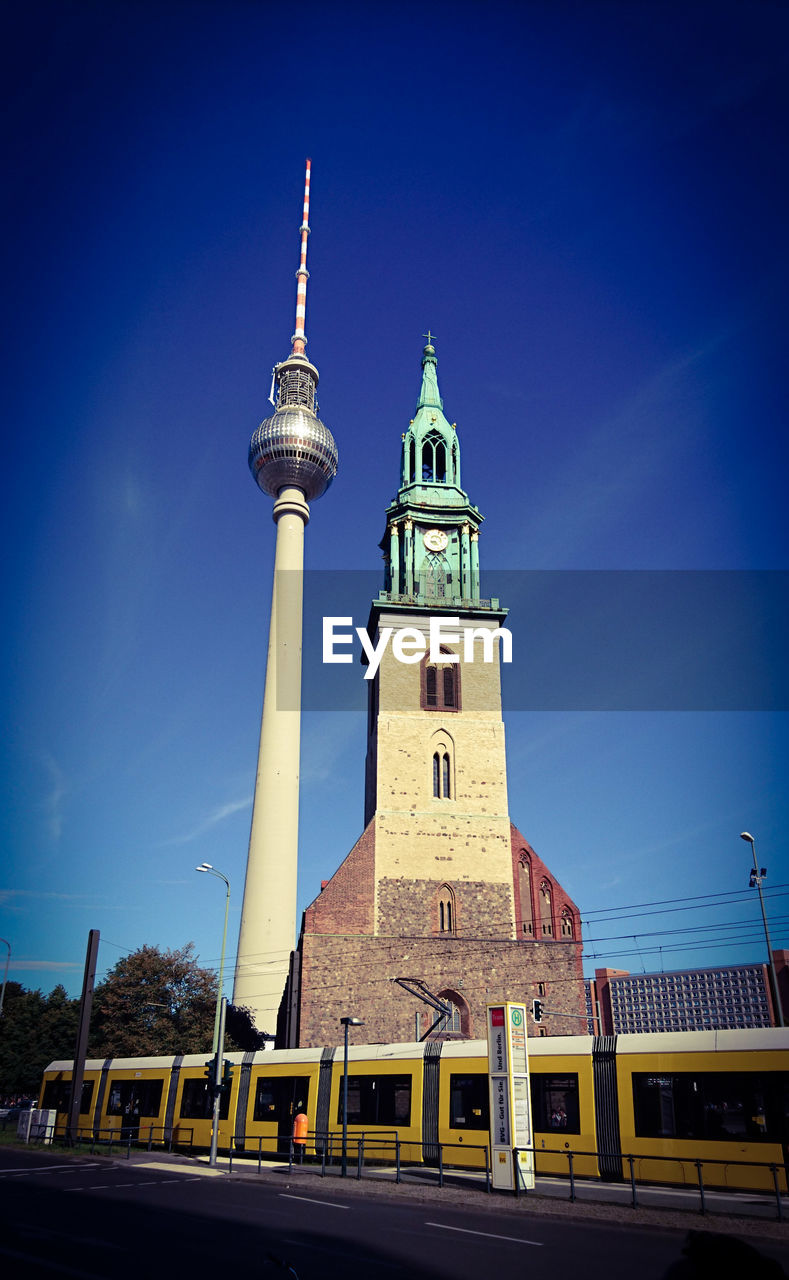 LOW ANGLE VIEW OF COMMUNICATIONS TOWER AGAINST BLUE SKY