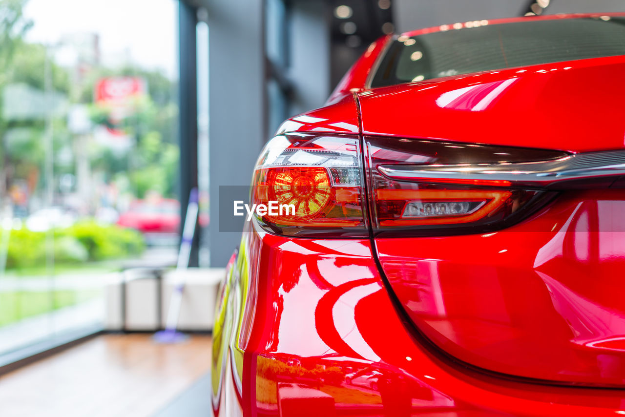 CLOSE-UP OF RED CAR WINDSHIELD