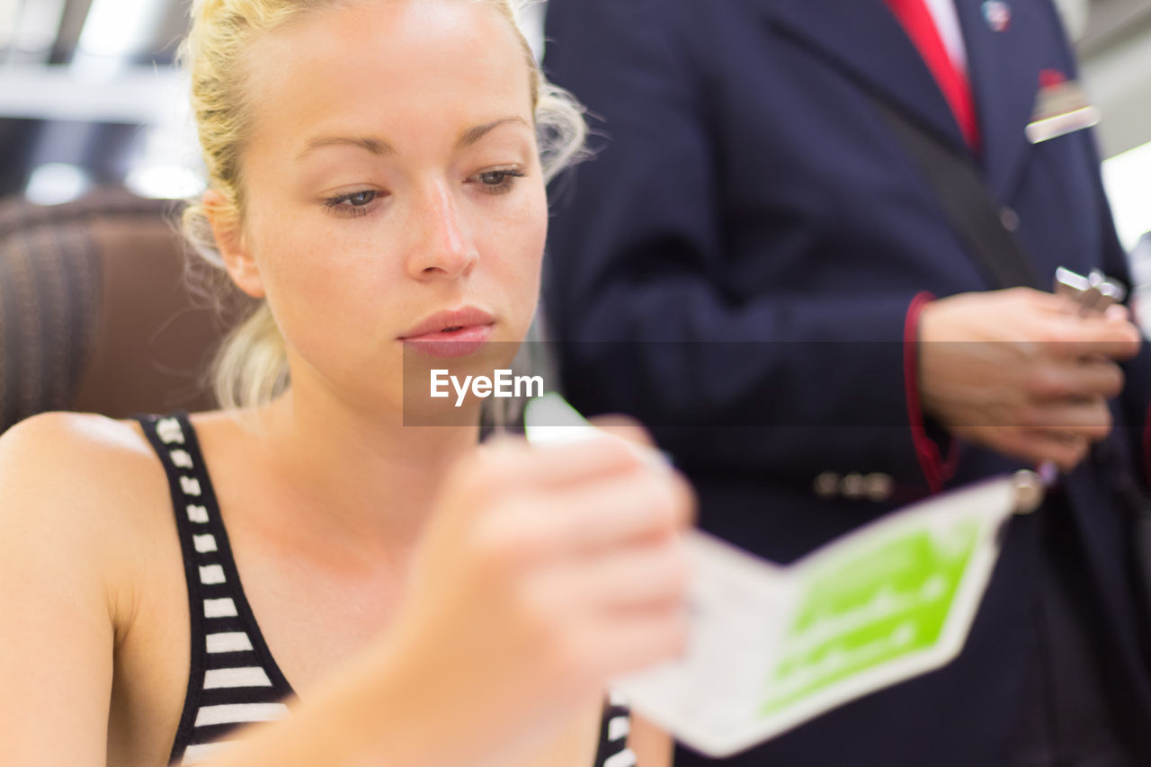 Close-up of beautiful woman sitting in train