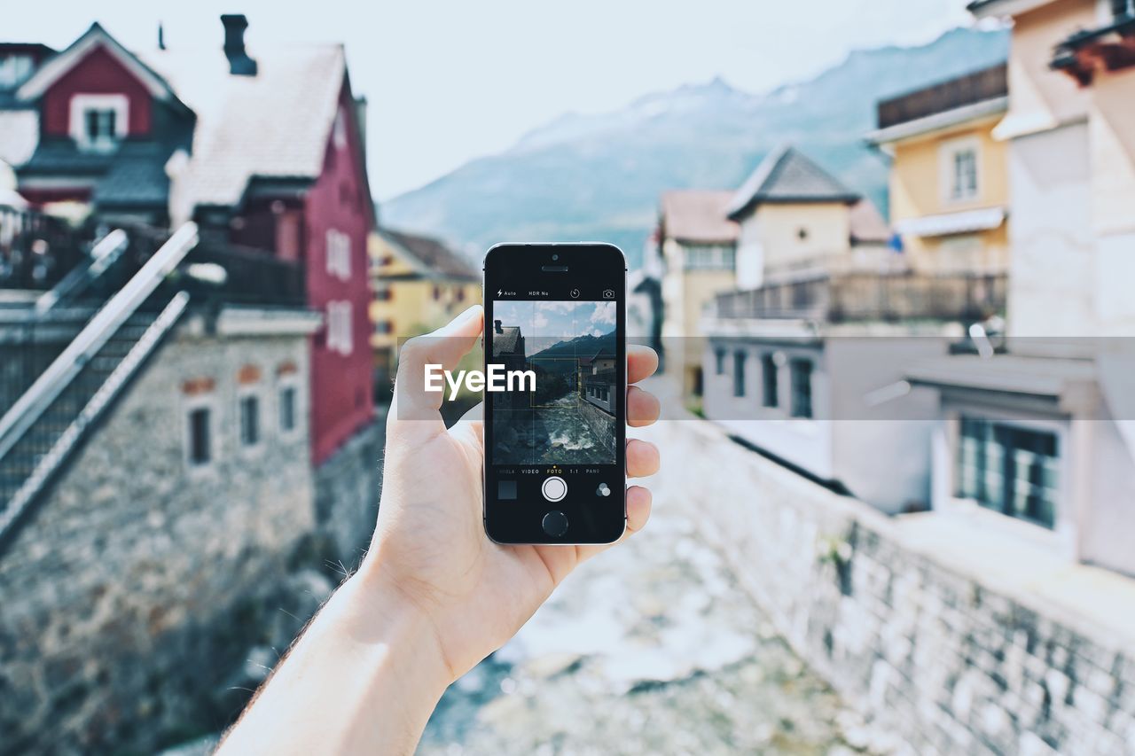 CROPPED IMAGE OF WOMAN HOLDING CAMERA