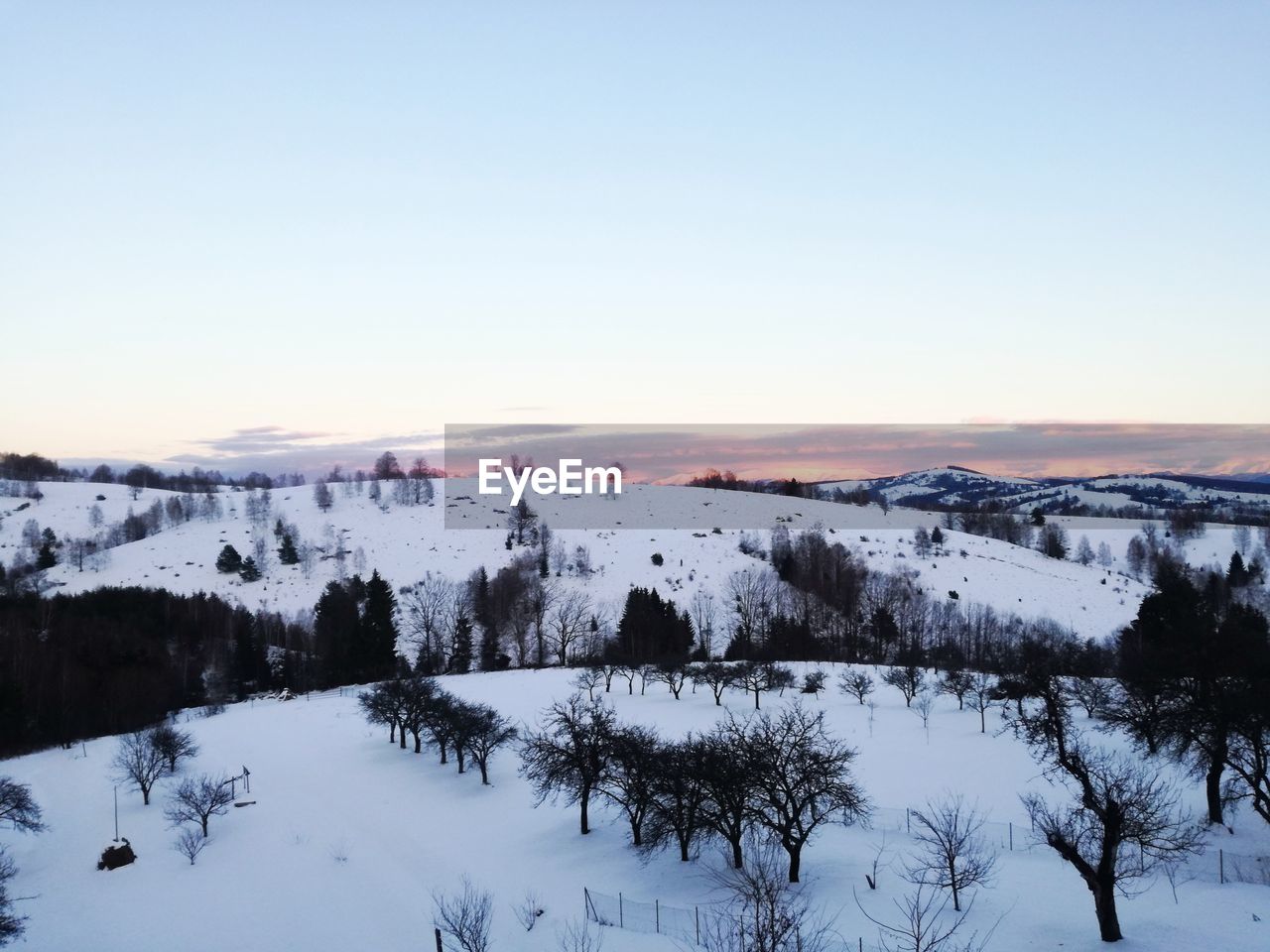 Scenic view of landscape against clear sky during winter