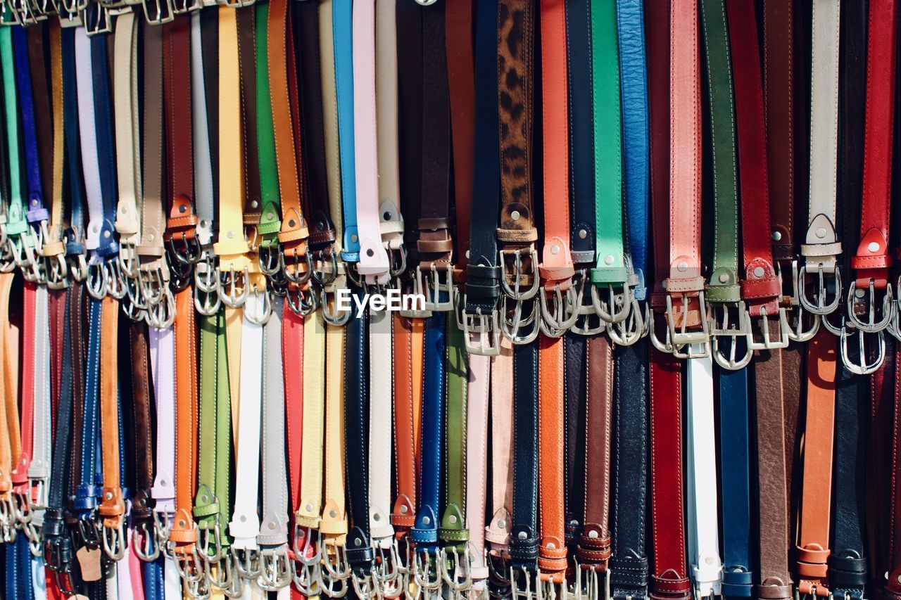 Leather belts hanging on stall