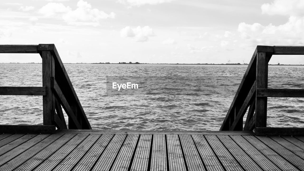 Pier over sea against sky