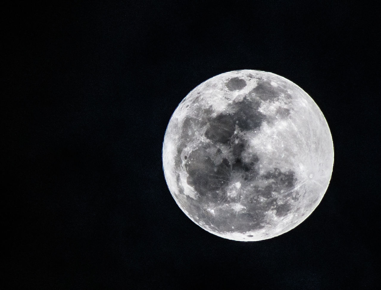 LOW ANGLE VIEW OF MOON AGAINST BLACK BACKGROUND