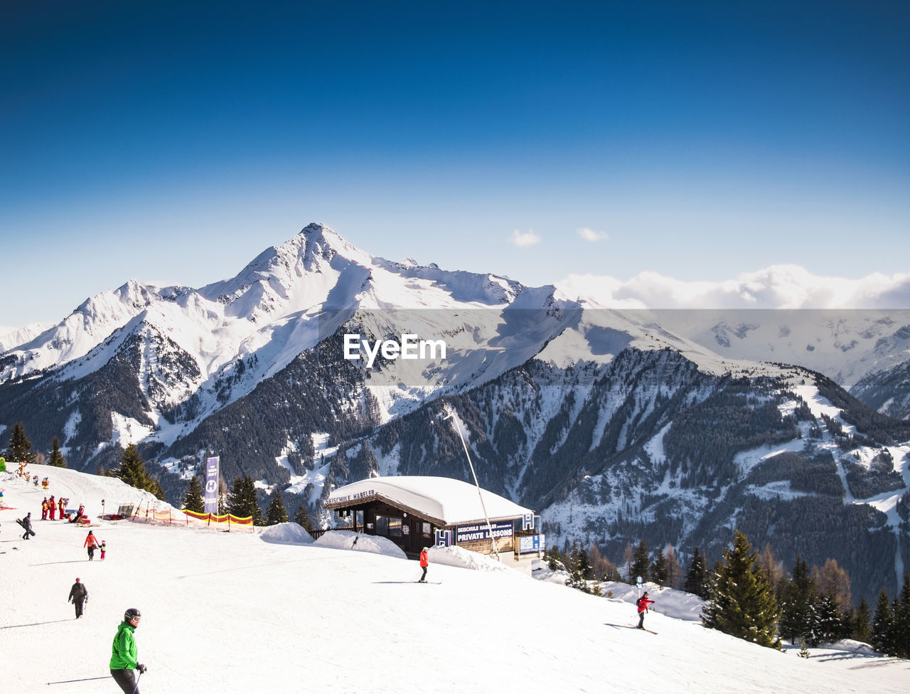 People skiing on snow covered mountain