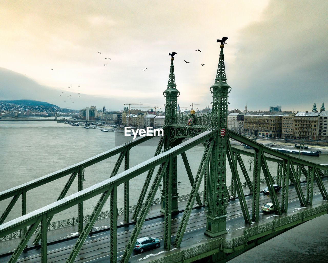View of bridge over river against cloudy sky