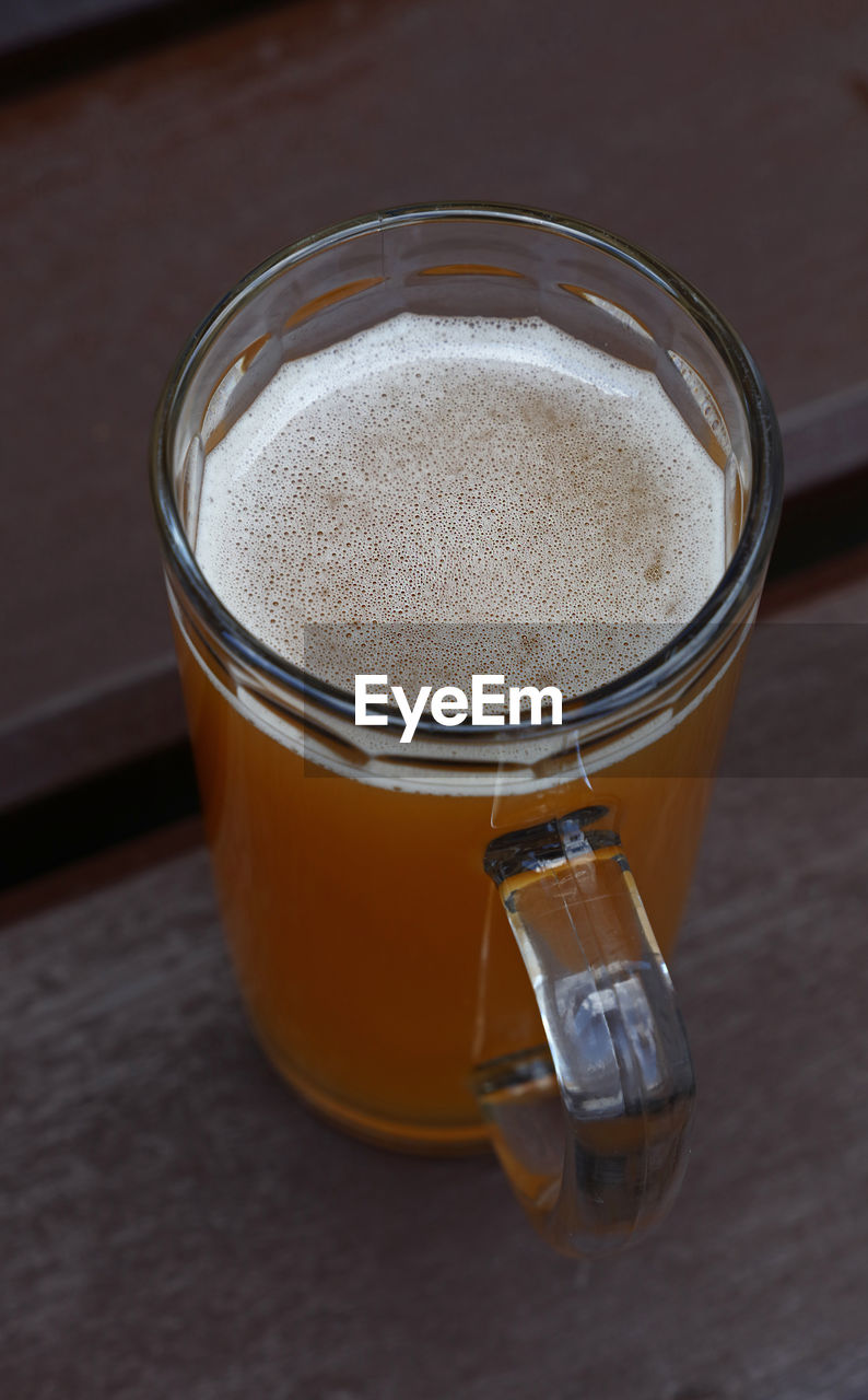 High angle view of beer glass on wooden table