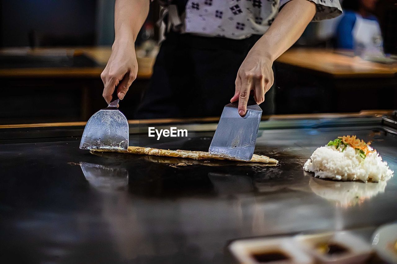 Midsection of person preparing food