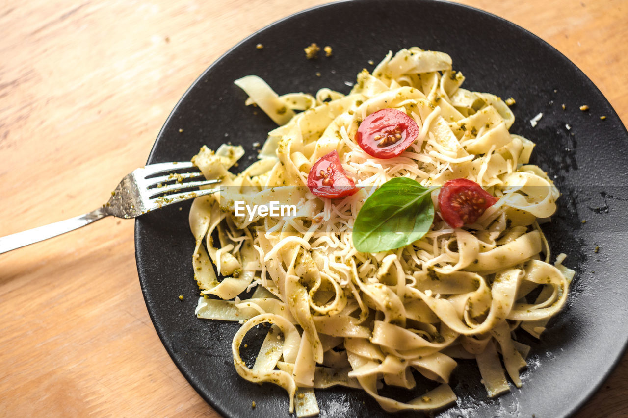 Close-up of served pesto pasta on plate