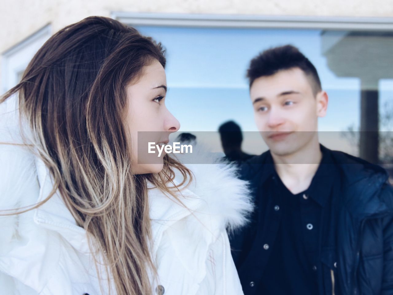 Couple looking at each other while standing outdoors