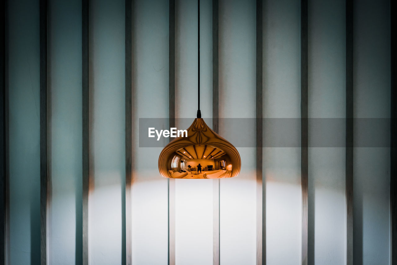 Close-up of pendant light hanging on wall