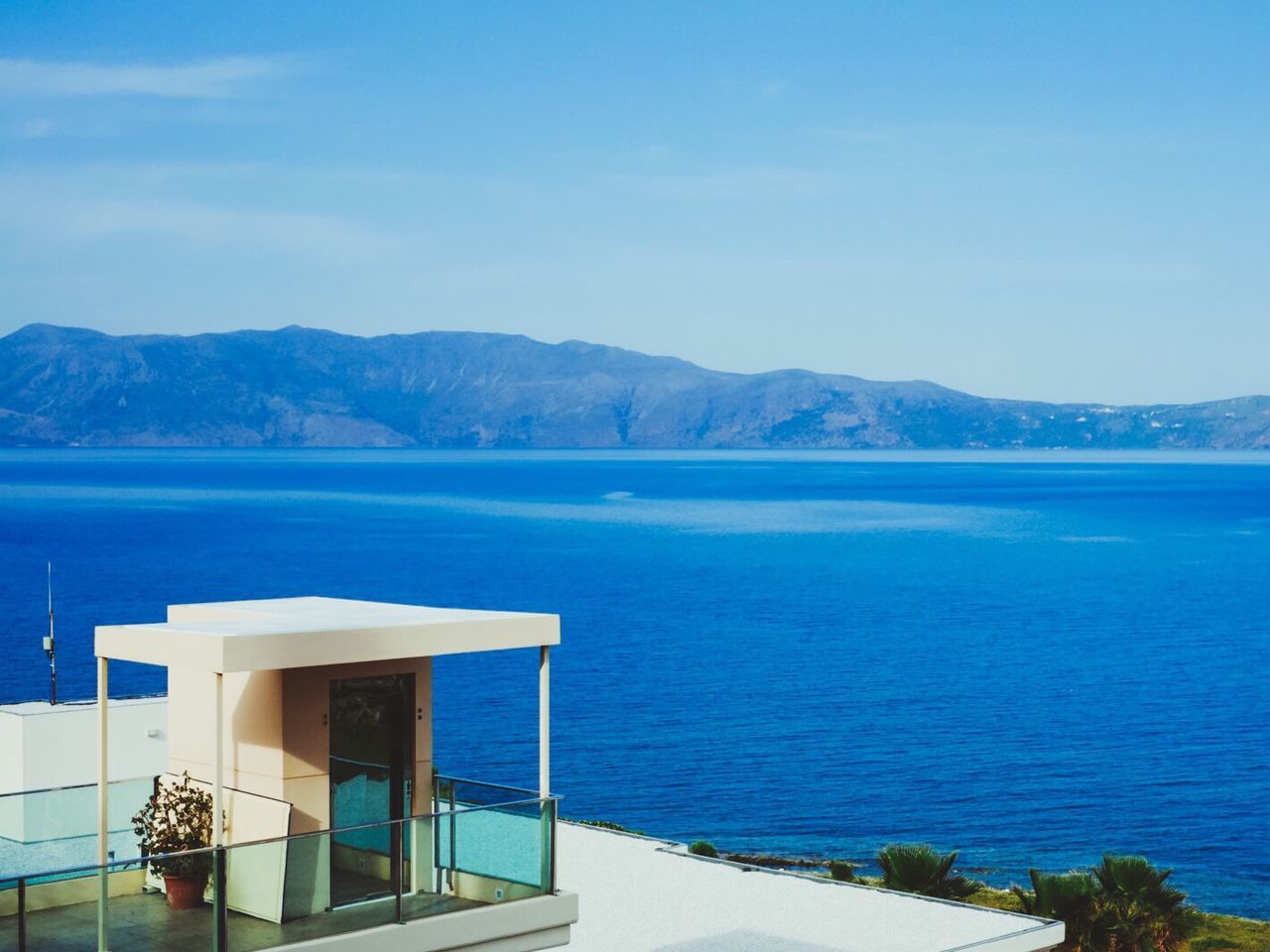 Built structure at porch overlooking ocean against sky