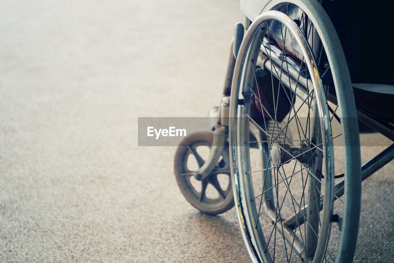 Close-up of wheelchair on road