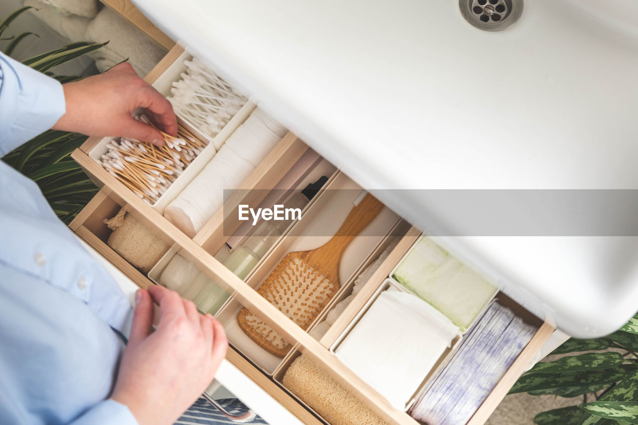 high angle view of man using mobile phone in bathroom