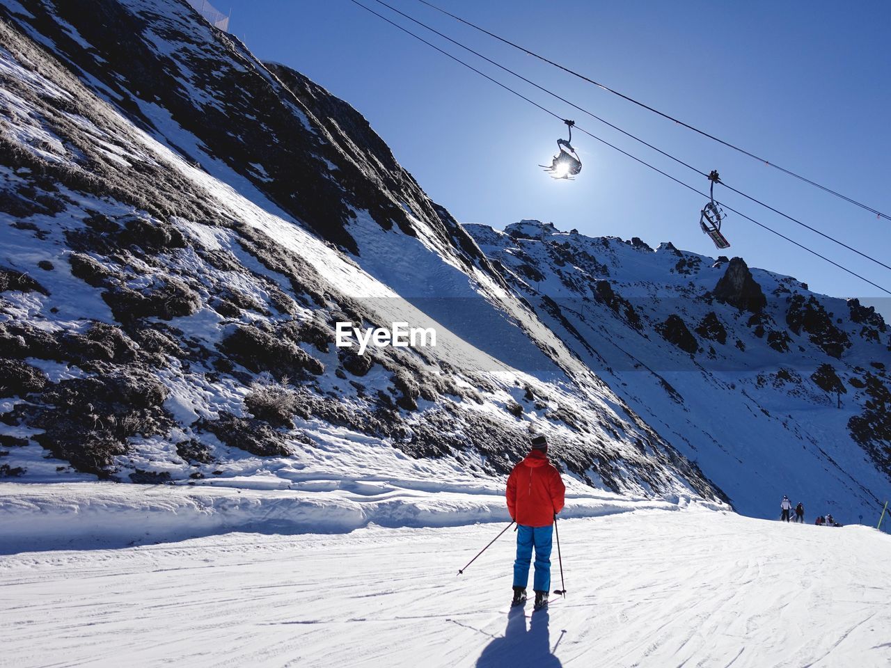 Rear view of skier on snow covered mountain