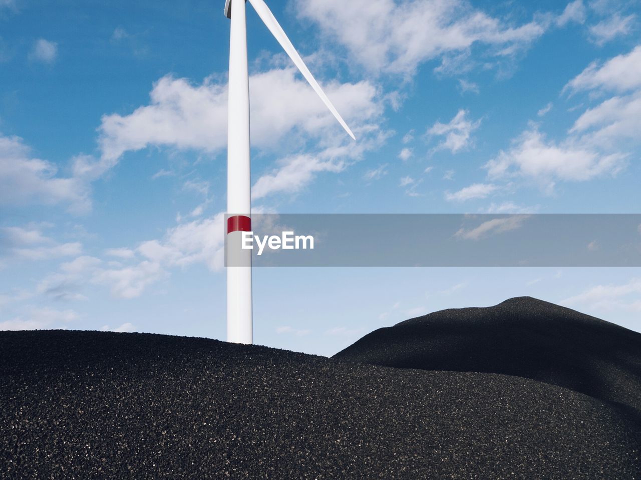 Low angle view of wind turbine against sky