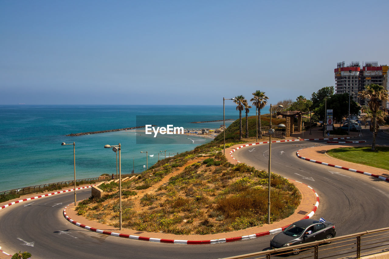 Scenic view of sea by city against sky