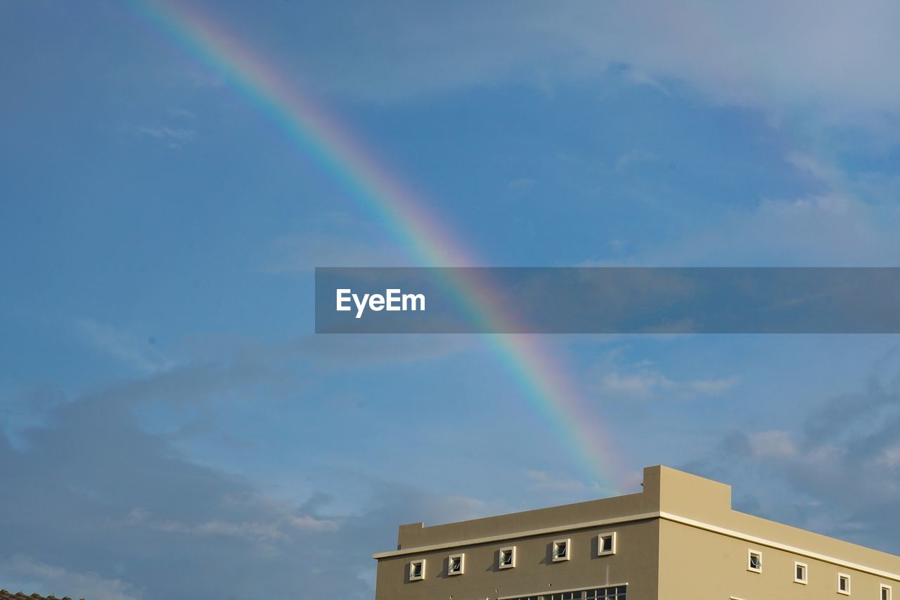 LOW ANGLE VIEW OF RAINBOW OVER BUILDING