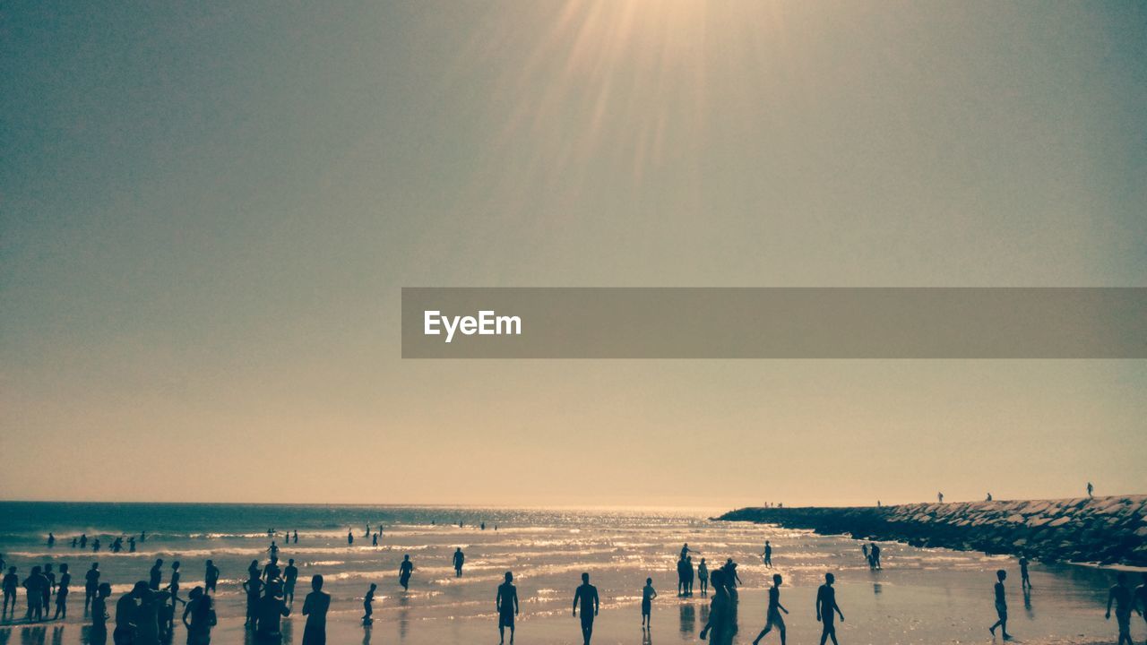 People enjoying at beach during summer