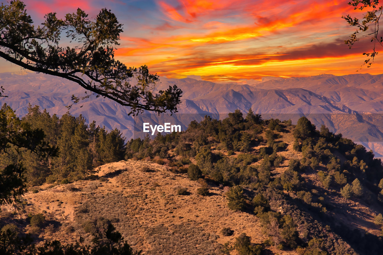 SCENIC VIEW OF MOUNTAINS AGAINST SKY AT SUNSET