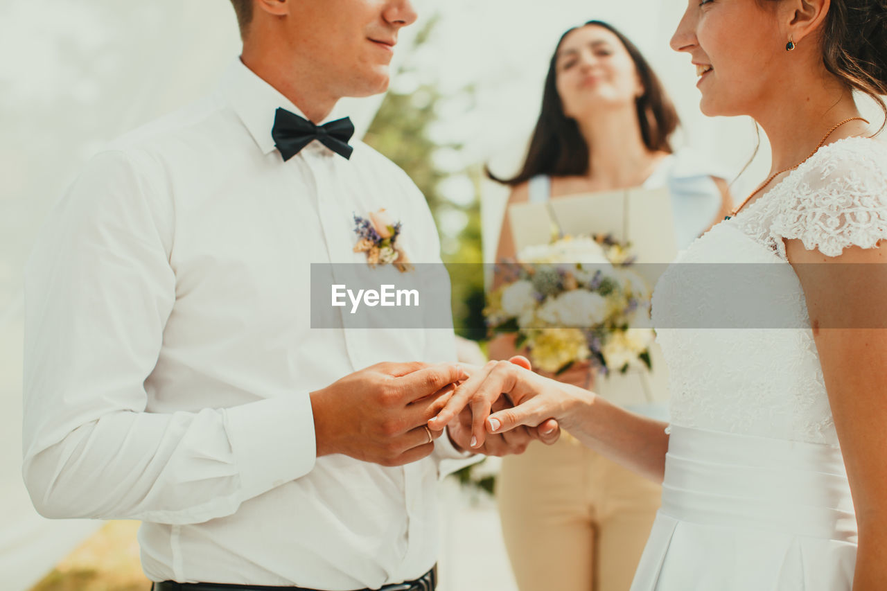 Midsection of couple holding hands