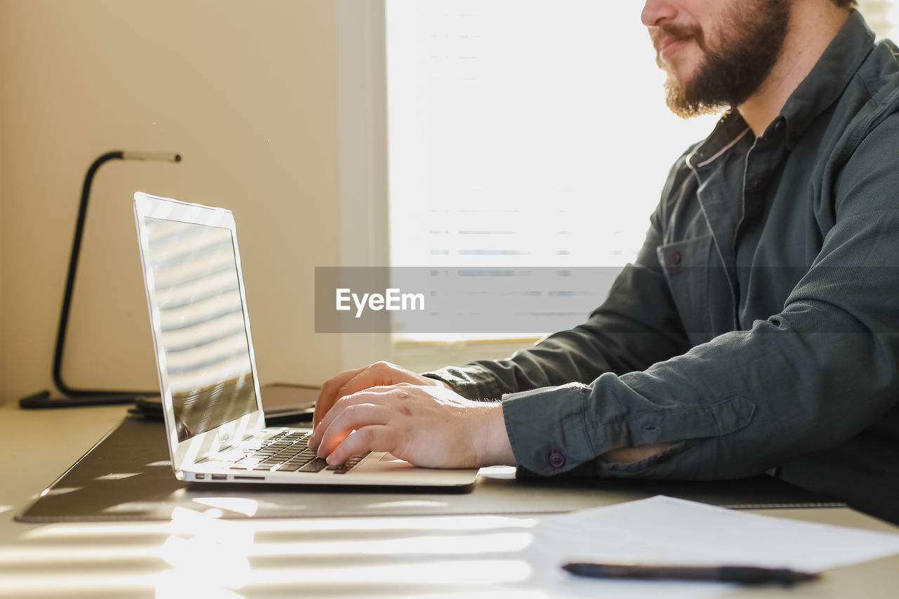 Man using laptop on table