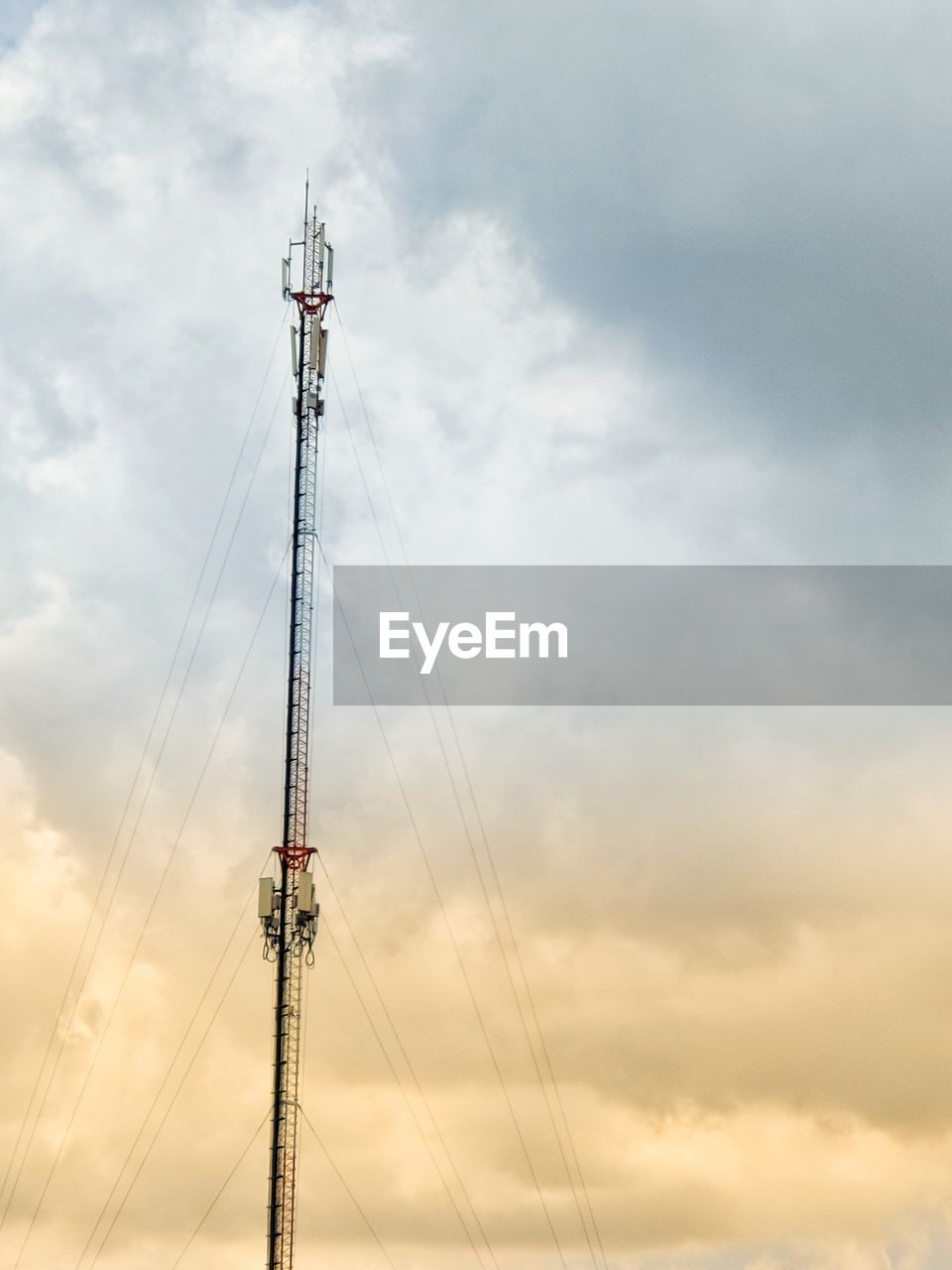 Low angle view of communications tower against sky