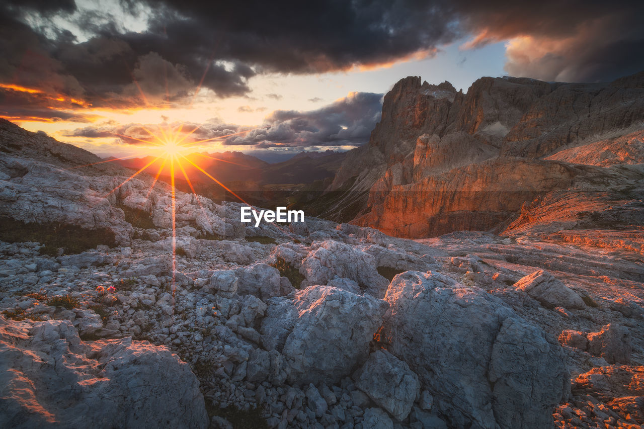 Moody landscape with dolomite mountains in perfect sunset light.