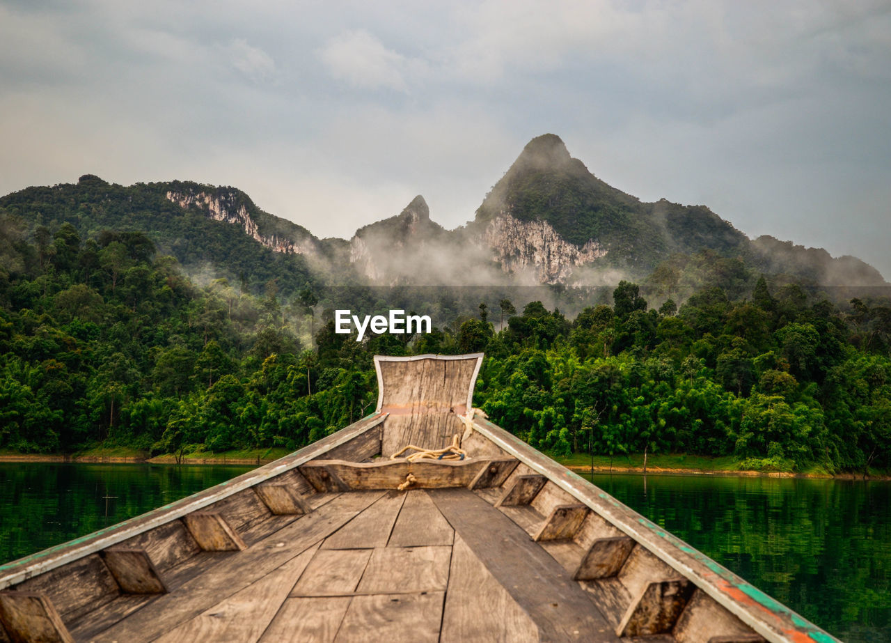 Boat on lake against mountains