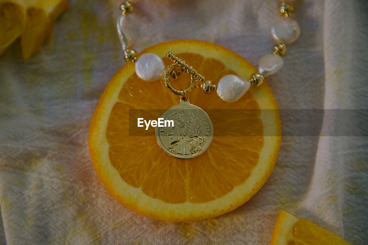 yellow, orange, necklace, jewelry, jewellery, close-up, fruit, no people, citrus fruit, indoors, fashion accessory, healthy eating, food and drink, amber, food, lemon, citrus, leaf