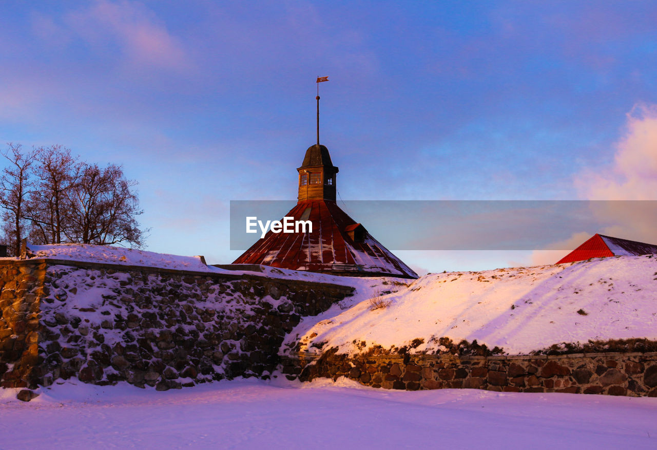 Snow covered landscape against sky