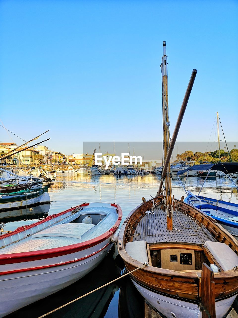 transportation, nautical vessel, water, mode of transportation, sky, sea, vehicle, boat, moored, nature, architecture, clear sky, no people, harbor, blue, travel, travel destinations, watercraft, day, dock, marina, city, outdoors, built structure, ship, building exterior, pier, sunny, sunlight, mast, sailboat