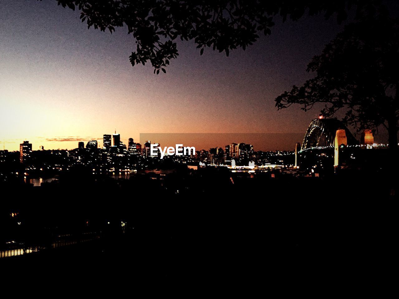 VIEW OF ILLUMINATED CITY AT NIGHT